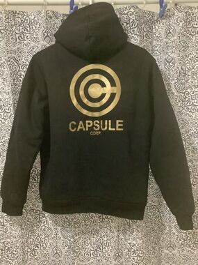 CAPSULE Corp. Black Hoodie with Gold Logo